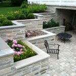 natural limestone veneered over the concrete a terraced retaining wall