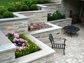 natural limestone veneered over the concrete a terraced retaining wall