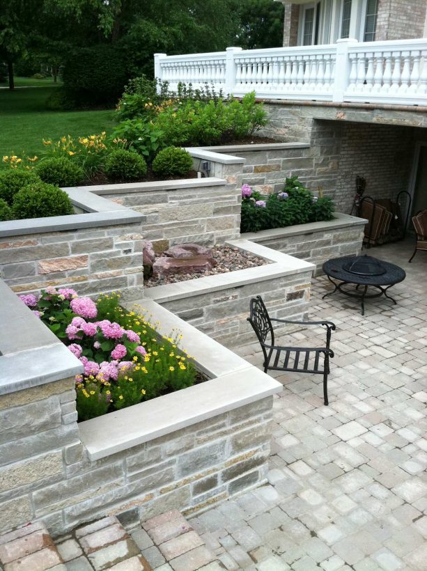 natural limestone veneered over the concrete a terraced retaining wall