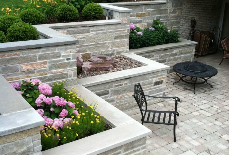 natural limestone veneered over the concrete a terraced retaining wall