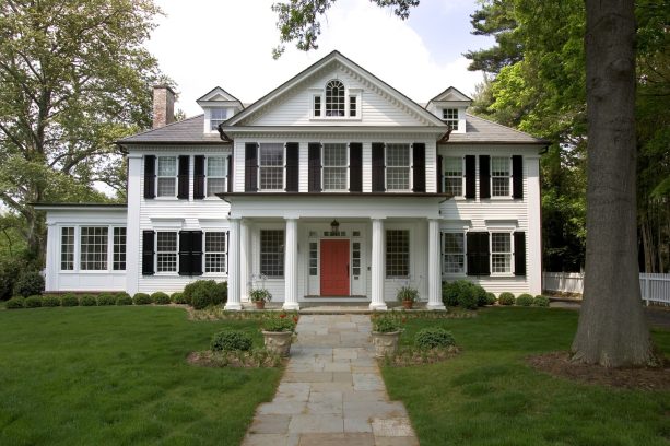 orange colonial front door to contrast the black and white exterior