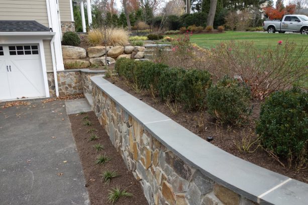 real stone veneer retaining wall with bluestone stair treads