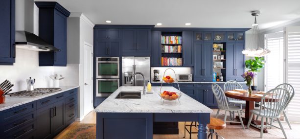 recessed-paneled navy cabinets beautifully pop off white granite kitchen countertops