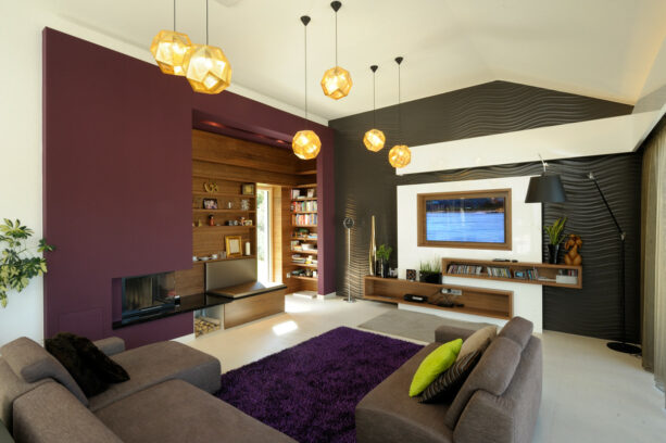 a cute white accent media wall in a room dominated by purple and dark grey