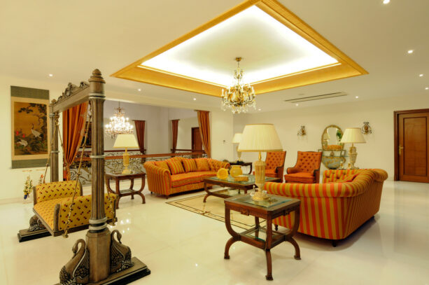 a large white and gold trey ceiling defines a grand traditional living room
