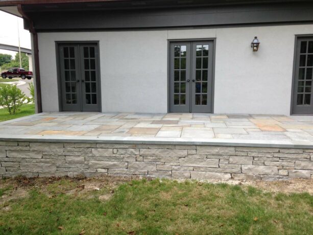 a multicolor raised patio paver on stone walls is for those who love anything full of sparks