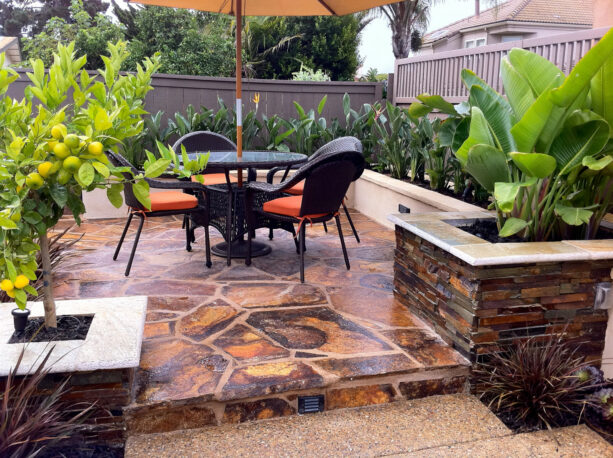 a raised patio with a slab flagstone paver was finished using a sealant to give it a slight sheen