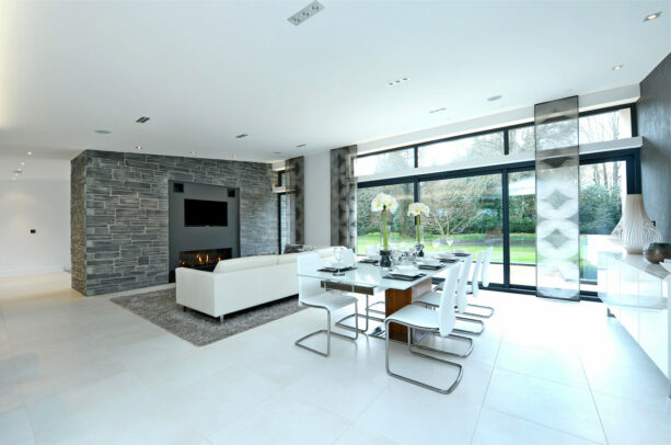 a textured stone wall and a smoother one painted in the grey form an elegant combo of two accent walls