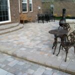 a unilock brussels block raised paver at an elegant traditional patio