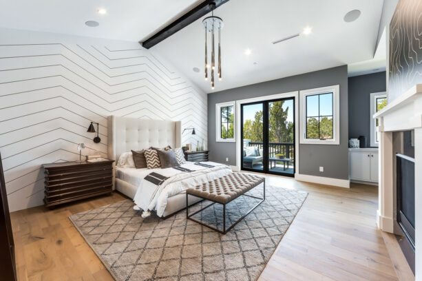 a white chevron accent wall provides a sophisticated contrast with dark grey main walls