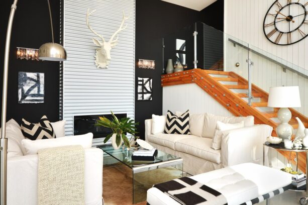a white corrugated metal accent wall with a deer head decoration surrounded by walls painted in black