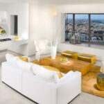 a white couch and gold ottomans make a luxurious contemporary living room