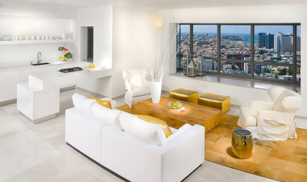 a white couch and gold ottomans make a luxurious contemporary living room
