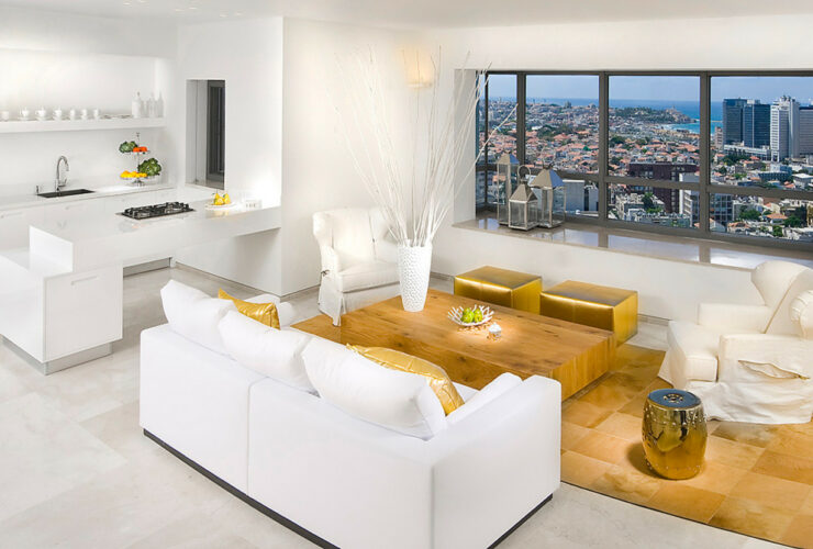 a white couch and gold ottomans make a luxurious contemporary living room