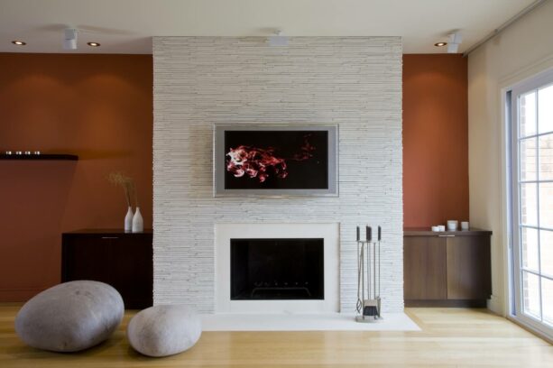 a white stacked stone accent wall beautifying a living room with duron sw 6342 spicy hue main walls