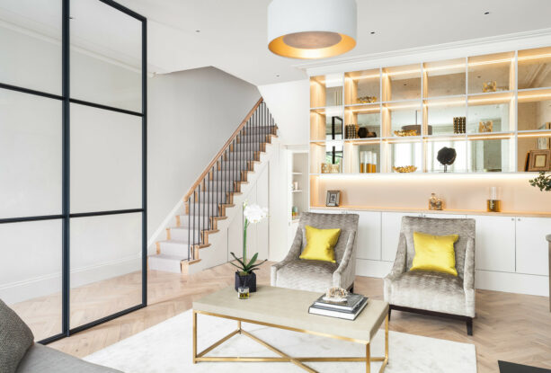 glimmering gold lights add richness to a living room dominated by white