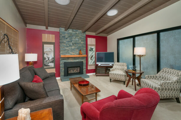 two accent walls consist of a combined red wall and a stacked stone one