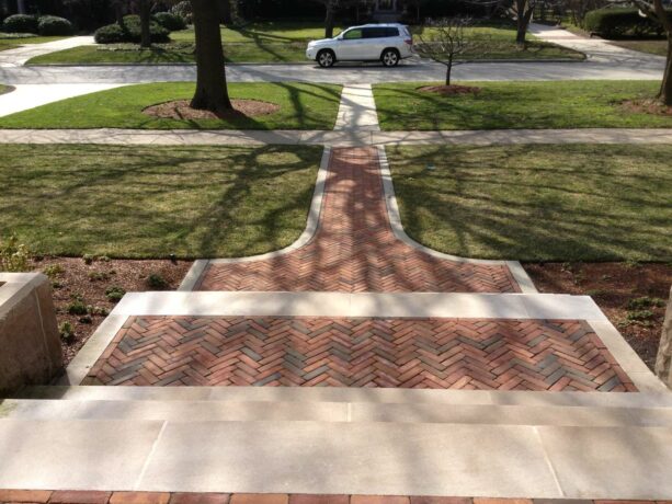 a clay paver with a washed antiqued concrete edging idea for a traditional walkway