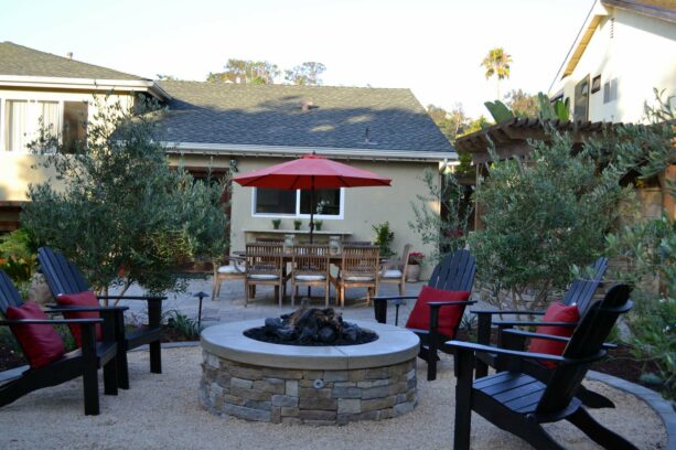 a crushed stone patio with a creamy gravel floor and a stone veneer firepit