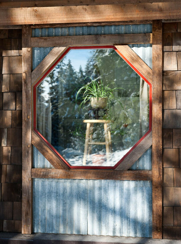 a rustic hexagonal window trim gives a mountain cabin a unique appearance