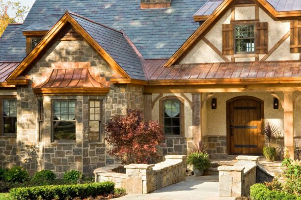 a rustic wooden arched window trim suits a stone exterior majestically