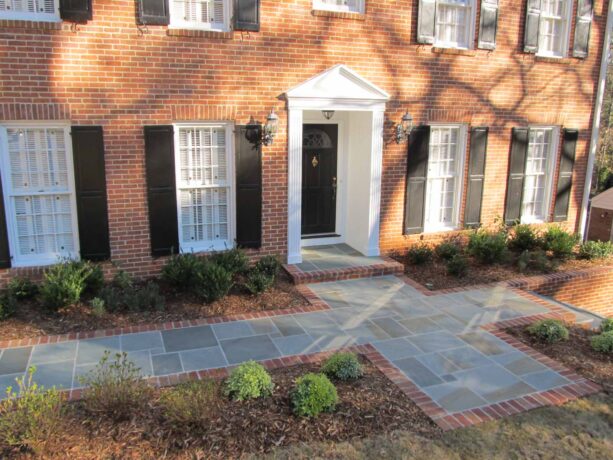 a thermal finish bluestone paver with brick edging for an elegant walkway