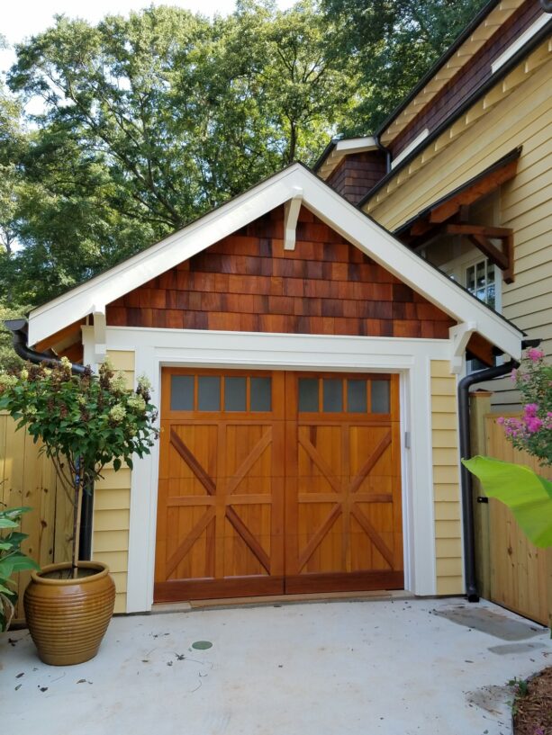 a white craftsman garage door trim freshens up a garage siding of browns
