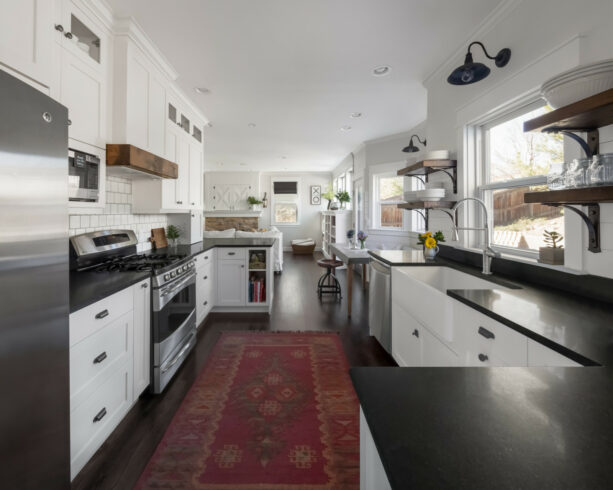 a black and white farmhouse galley kitchen with two identical peninsulas