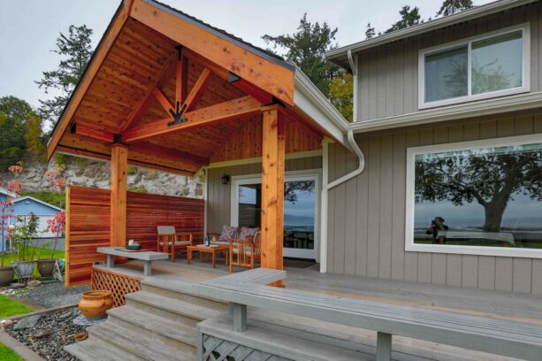 a bright cedar patio cover contrasts gorgeously against the grey exterior