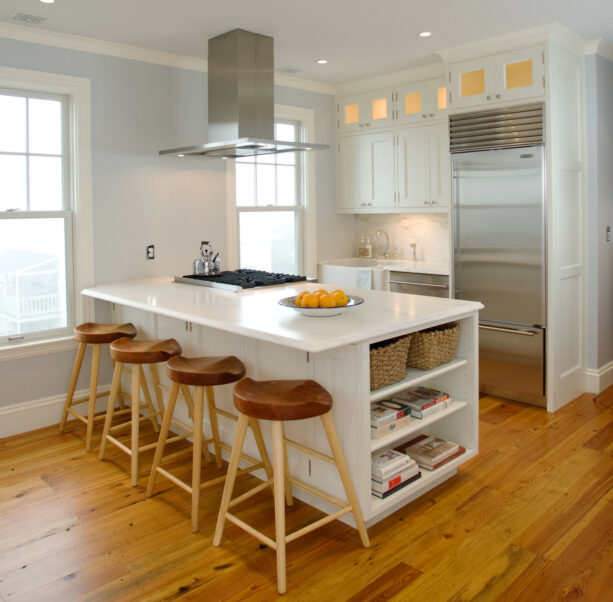 a galley kitchen whose peninsula has shelves for additional storage