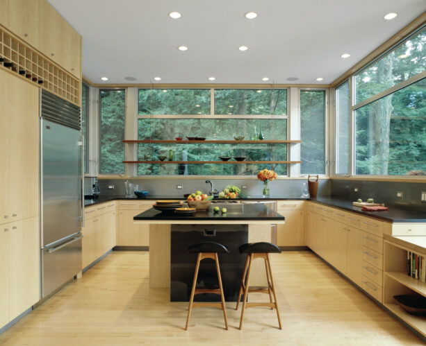 a pair of long brown wooden shelves decorate a wide clear window