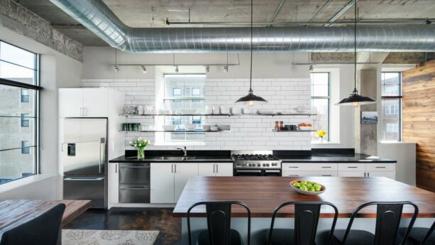 an industrial kitchen welcomes shiny metal window shelves