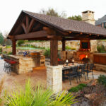 medium brown stained cedar patio cover looks classy, hovering over a traditional outdoor space