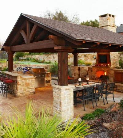 medium brown stained cedar patio cover looks classy, hovering over a traditional outdoor space